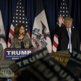 Republican presidential candidate Donald Trump acknowledges the crowd as former Alaska Gov. Sarah Palin speaks at Hansen Agriculture Student Learning Center at Iowa State University on January 19, 2016.