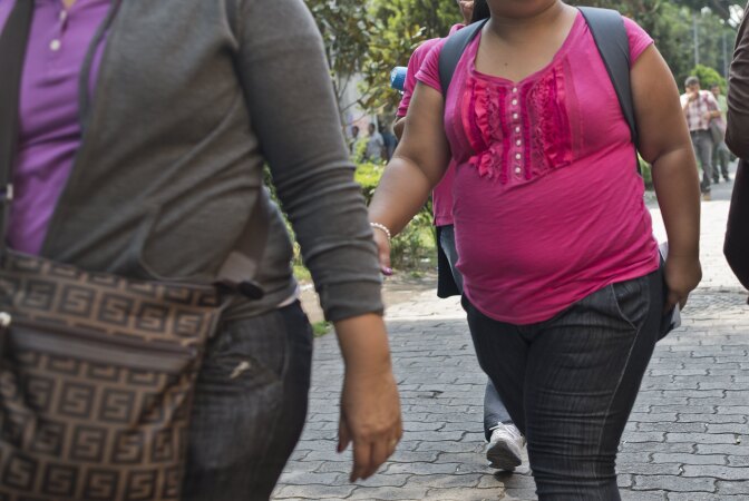 Women with obesity walk along a street in Mexico City on May 20, 2013. Obesity among Mexicans soared from 9.5% in 1988 to 32% in 2012 and if overweight is included, up to 70%. Mexicans also contribute with 22,000 out of the 180,000 people who die annually in the world from conditions related to the intake of sweet drinks, a figure that doubles the 10,000 deaths caused by the organized crime in the country.