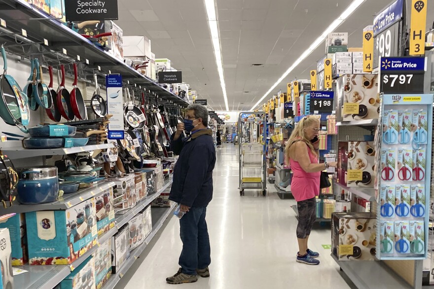FILE - Consumers shop at a Walmart store in Vernon Hills, Ill., Sunday, May 23, 2021. U.S. consumer confidence fell in August to the lowest level since February amid rising concerns about the rapidly spreading delta variant of the coronavirus and worries about higher inflation. The Conference Board reported Tuesday, Aug. 31, 2021 that its consumer confidence index dropped to a reading of 113.8 in August, down from a revised 125.1 in July. (AP Photo/Nam Y. Huh, file)