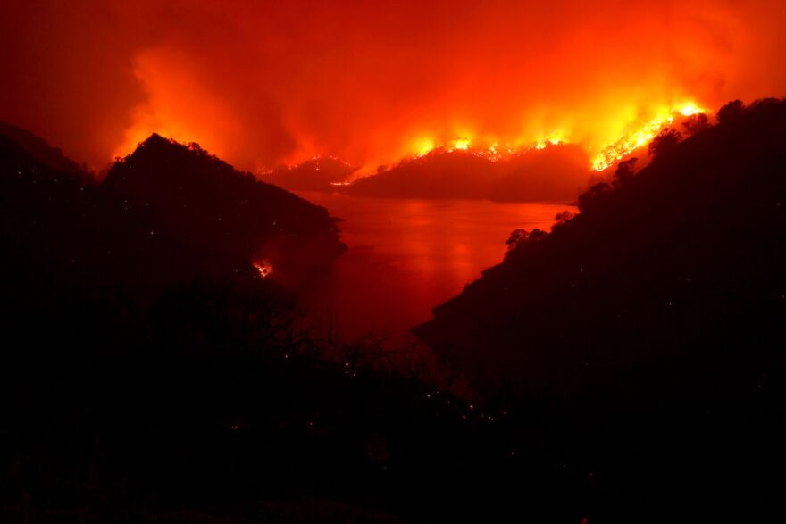 NAPA, CALIFORNIA - AUGUST 19: The LNU Lightning Complex fire burns in the hills surrounding Lake Berryessa on August 19, 2020 in Napa, California. The LNU Lightning Complex fire is spread over 5 counties and has burned over 124,000 acres. The out-of-control wildfire has destroyed at least 50 homes and is zero percent contained. (Photo by Justin Sullivan/Getty Images)