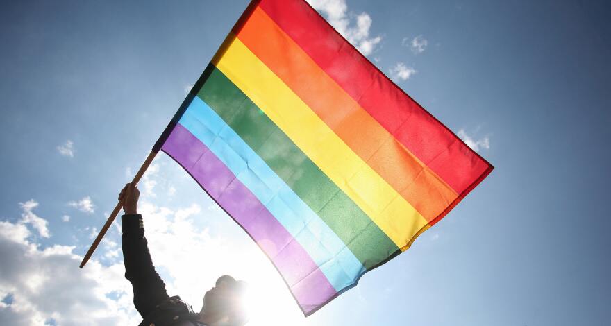 A participant waves a rainbow flag as he takes part in the Gay Pride Parade on June 7, 2008 in Warsaw, Poland.