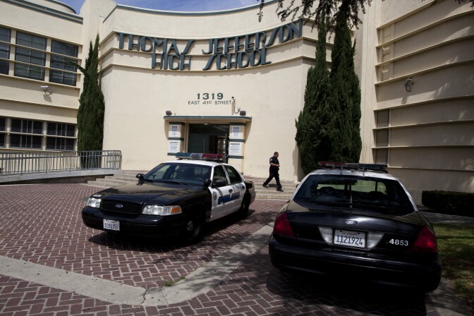 Los Angeles Police cruisers are parked out side of Jefferson High School to keep an eye on a student protest against a district-wide scheduling system that has kept them out of the classes they need to graduate.