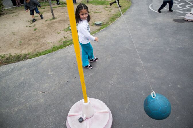 Ashley Vargas, who is enrolled in the transitional kindergarten (TK) program, plays tether ball during recess at the Martha Escutia Primary Center. TK is meant to bridge the academic gap between preschool and kindergarten.