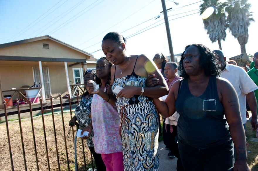 Unique Russell's family (Emily Sharp-Williams, Alma Smith, Belinda Brooks, and Delintha Jones, left to right) lead the march back to the family home where it began.