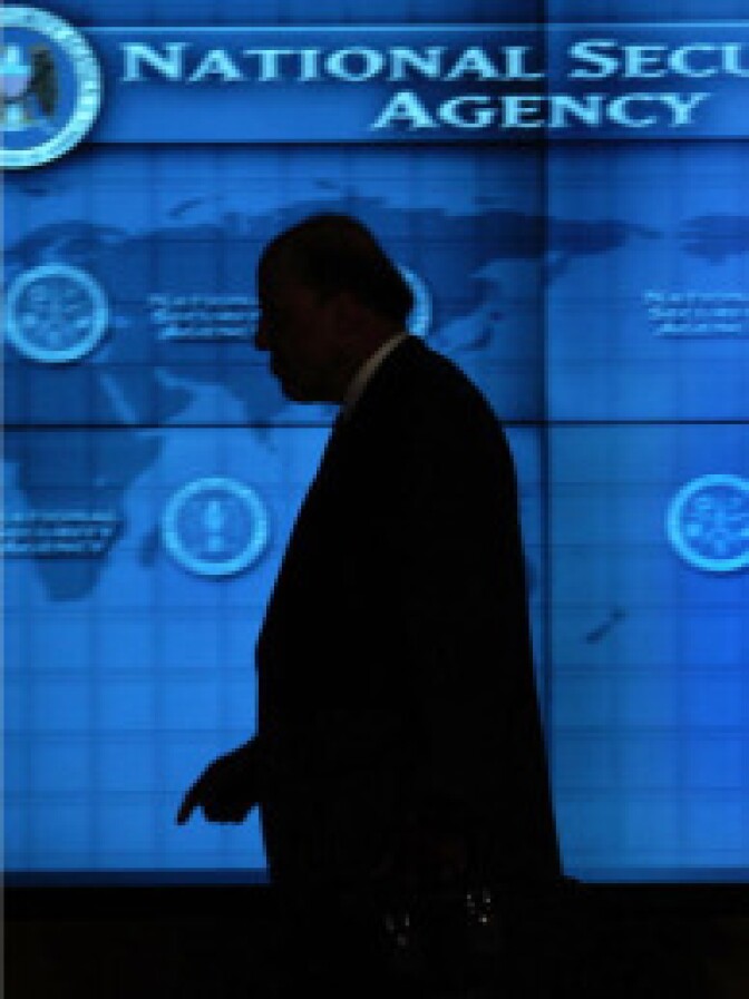 Former Director of National Intelligence John Negroponte walks the hallways of the Threat Operations Center inside the National Security Agency in Fort Mead, Maryland in this January 25, 2006 file photo