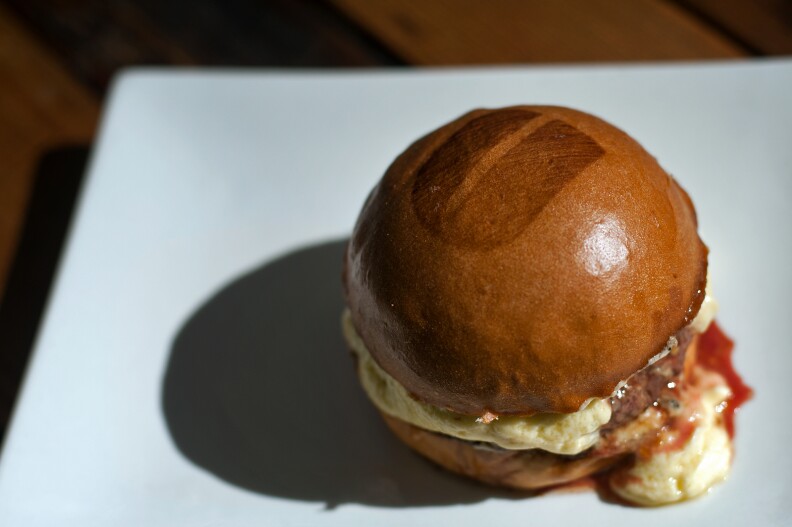 The Grove Truffle Burger, with parmesan fondue and truffle sauce, is exclusive to their flagship restaurant. Every Umami burger has a "U" on the top bun.