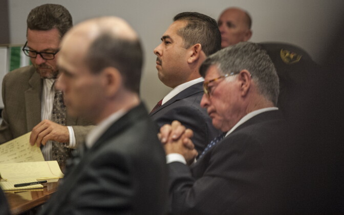 Former Fullerton police officer Manuel Ramos, center,  listens to the opening statement during his trial on Monday, Dec. 2, 2013 in Santa Ana, Calif.  Orange County District Attorney Tony Rackauckas told jurors that former Fullerton officers Ramos and Jay Cicinelli were responsible for the death of 37-year-old Kelly Thomas in July 2011. Thomas, whose family says was schizophrenic, died five days after the violent confrontation with six officers who responded to a call about a man jiggling car door handles in a transit center parking lot. Ramos is charged with second-degree murder and involuntary manslaughter. Cicinelli is charged with to involuntary manslaughter and use of excessive force.  Barnett portrayed Thomas as an unpredictably violent person in his opening statements. (AP Photo/The Orange County Register, Bruce Chambers, Pool)