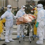 A person who is believed to be have been contaminated with radiation, wrapped with a blanket, is carried to ambulance at a radiation treatment centre in Nihonmatsu city in Fukushima prefecture on March 13, 2011.