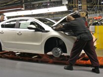 Workers assemble a Chevrolet Volt at GM's Detroit Hamtramck Assembly Plant in October. The auto maker says it will idle the plant for five weeks, to allow demand to catch up with inventory.