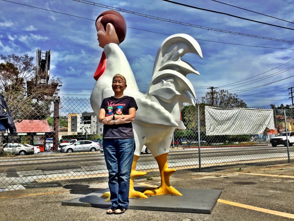 Amy Inouye, of Future Studio Gallery, with Deborah Brown's Cock Bob sculpture in Glassell Park. 