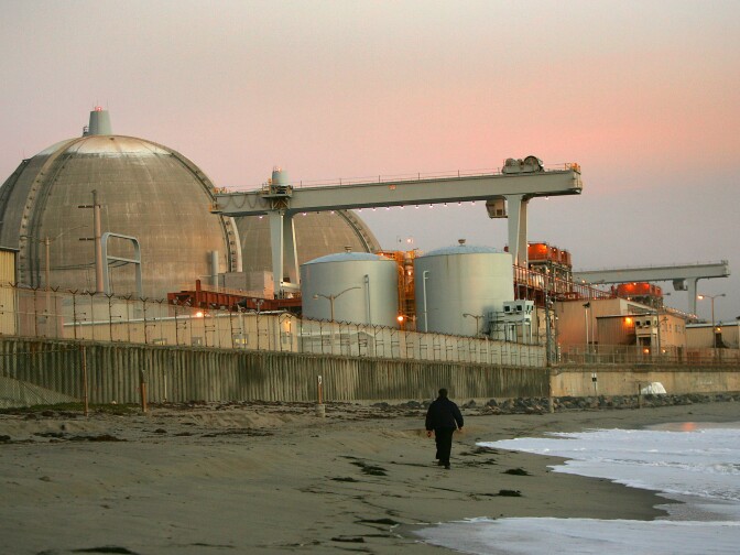 People living near the closed San Onofre nuclear plant hope to find out more about the dismantling of the plant and nuclear waste storage during a Tuesday night meeting of a community panel created by Southern California Edison. (File photo: Evening sets on the San Onofre atomic power plant December 6, 2004 in northern San Diego County, south of San Clemente, California. El