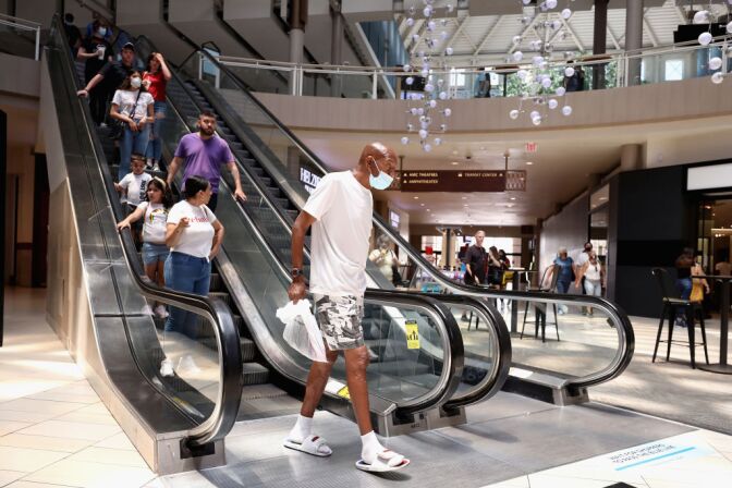 GLENDALE, ARIZONA - JUNE 20:  Consumers exit an escalator as they return to retail shopping at the Arrowhead Towne Center on June 20, 2020 in Glendale, Arizona. Arizona is one of the 19 states with the trend of new coronavirus (COVID-19) cases still increasing. Gov. Doug Ducey allowed individual Arizona cities to create their own policies about face-covering requirements and enforcement on Wednesday. (Photo by Christian Petersen/Getty Images)