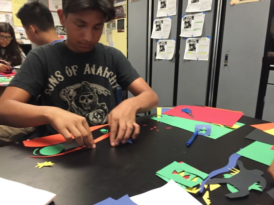 Mario Vasquez, an eighth grader at Fulton & Alsbury Academy of Art and Engineering, works on a cutout project in the style of Henri Matisse.