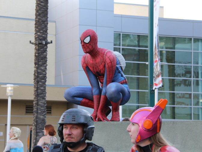 A cosplaying Spider-Man perches at WonderCon Anaheim 2015.