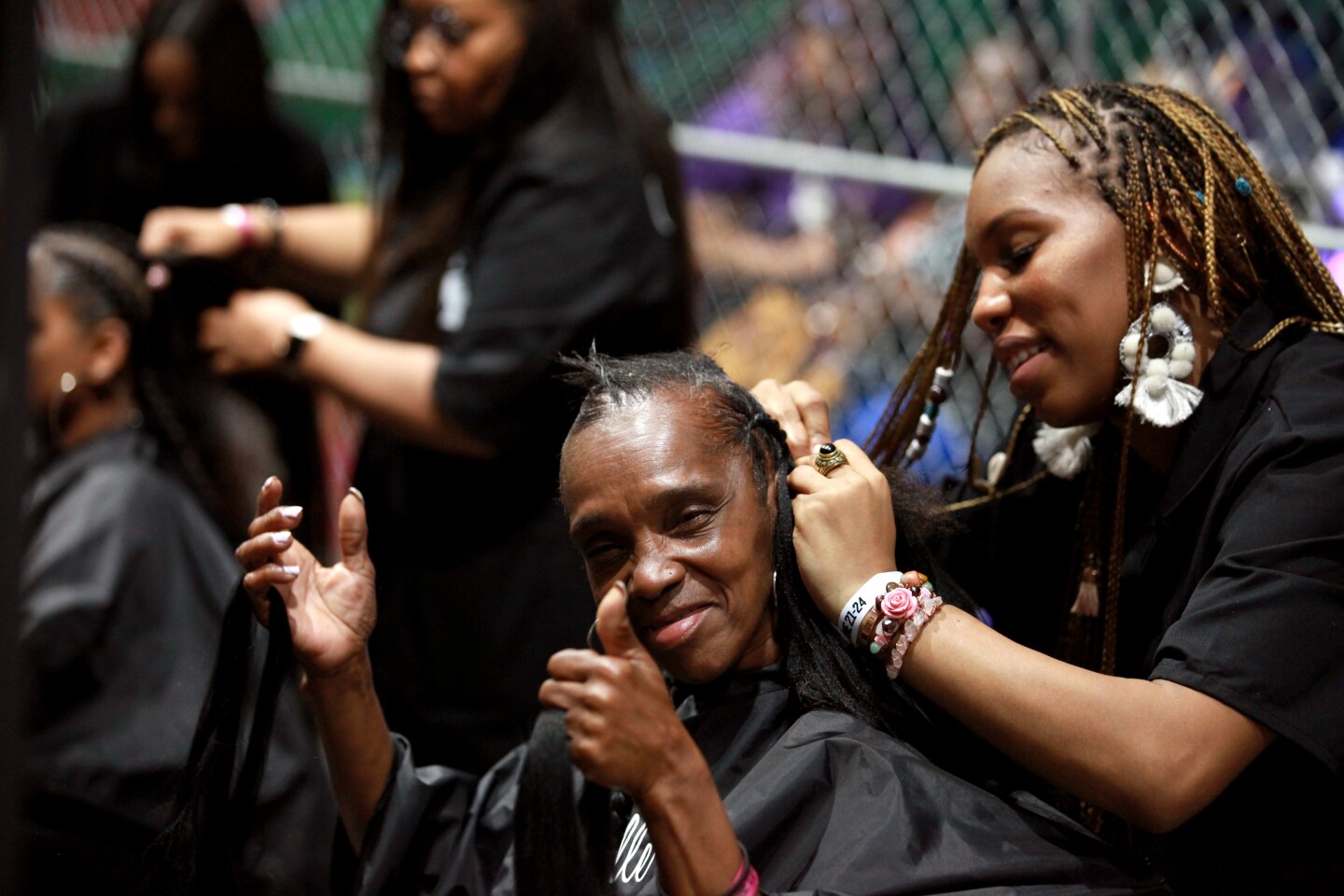 A Black woman gets her hair done at the BETX House of Fashion and Beauty at the 2018 BET Experience Fan Fest.