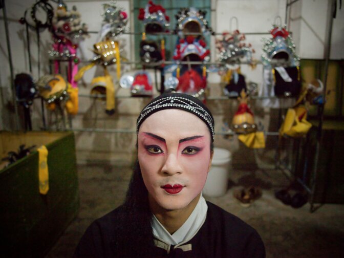 In China, Mazu, a folk goddess of the sea, has an estimated 160 million followers and 4,000 temples devoted to her. Cheng Zhigui, 23, is dressed to perform in a traditional opera during celebrations for Mazu's 1050th birthday on Meizhou Island in the southern province of Fujian. "We perform for Mazu. We believe she's watching us sing opera. Even if nobody came, she'd still be watching us," he says.