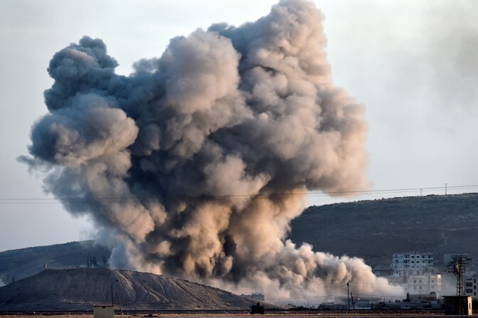 Smoke rises from the impact of an airstrike next to the hill where Islamic State (IS) militants had placed their flag in the Syrian town of Ain al-Arab, known as Kobane by the Kurds, seen from the Turkish-Syrian border in the southeastern village of Mursitpinar, Sanliurfa province, on October 8, 2014. The Pentagon warned on October 8, 2014 US air power on its own could not prevent Islamic State jihadists from capturing the Syrian border town of Kobane, even as US warplanes kept up bombing raids in the area.