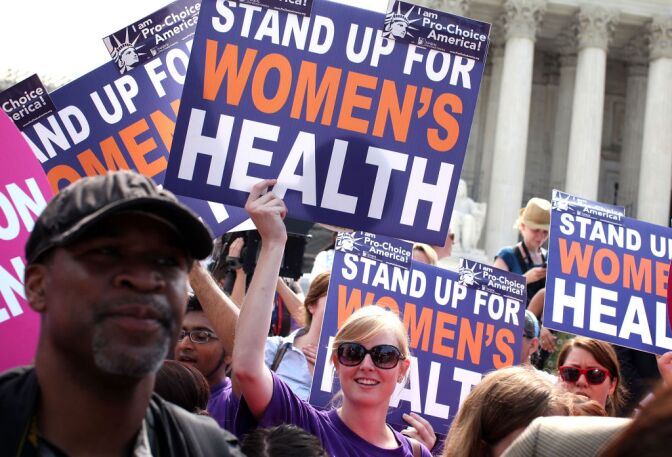 Obamacare supporters celebrate as they respond to the Supreme Court ruling on the Affordable Health Act June 28, 2012 in front of the U.S. Supreme Court in Washington, DC. The Supreme Court has upheld the whole healthcare law of the Obama Administration. 
