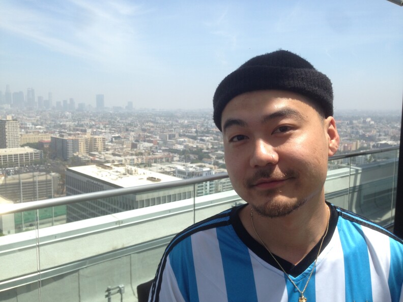 Rapper Dumbfoundead, whose real name is Jonathan Park, stands on the roof of his apartment building overlooking Koreatown