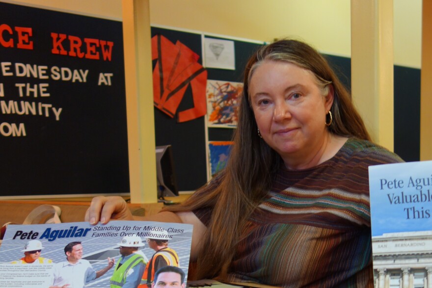 Jill Vassilakos-Long of San Bernardino shows some of the many mailers sent to her home during the primary election in the 31st Congressional District.