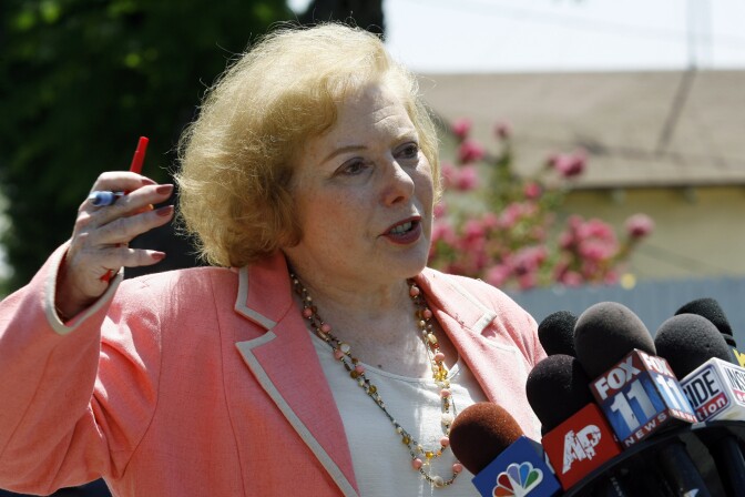 ALHAMBRA, CA - AUGUST 9: Linda Deutsch, the designated court pool reporter, comments on the visit of panel of jurors to the home of music producer Phil Spector to view the crime scene August 9, 2007 in Alhambra, California. Spector, 67, is accused of fatally shooting 40-year-old Lana Clarkson in February 2003.  (Photo by Damian Dovarganes-Pool/Getty Images) *** Local Caption *** Linda Deutsch