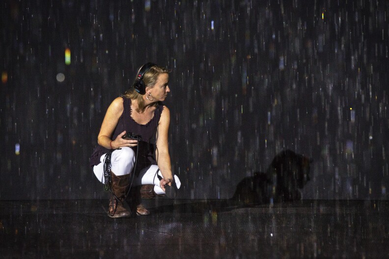 The Frame's Darby Maloney records sound of the Rain Room at LACMA during the press preview on Wednesday morning, Oct. 28, 2015.