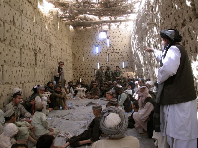 About three dozen Afghan elders and villagers attend a meeting with Afghan and U.S. troops at the  American compound in Panjwaii, about 15 west of the city of Kandahar.
