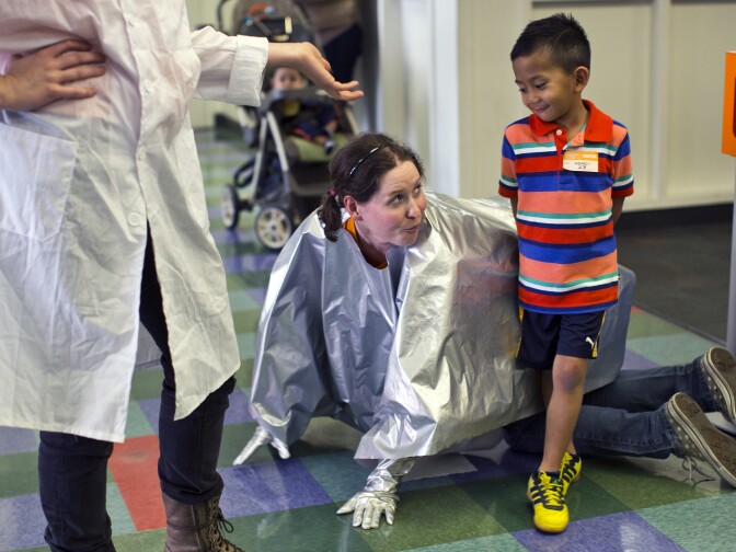Actress Katie Curley plays a robot alongside 7-year-old Sebastian Galingan during a skit in the AltaMed Outpatient Waiting Room at Children's Hospital Los Angeles on Feb. 23, 2015. Curley and her acting partner perform skits in outpatient waiting rooms, lobbies, the infusion center and inpatient rooms and playrooms.