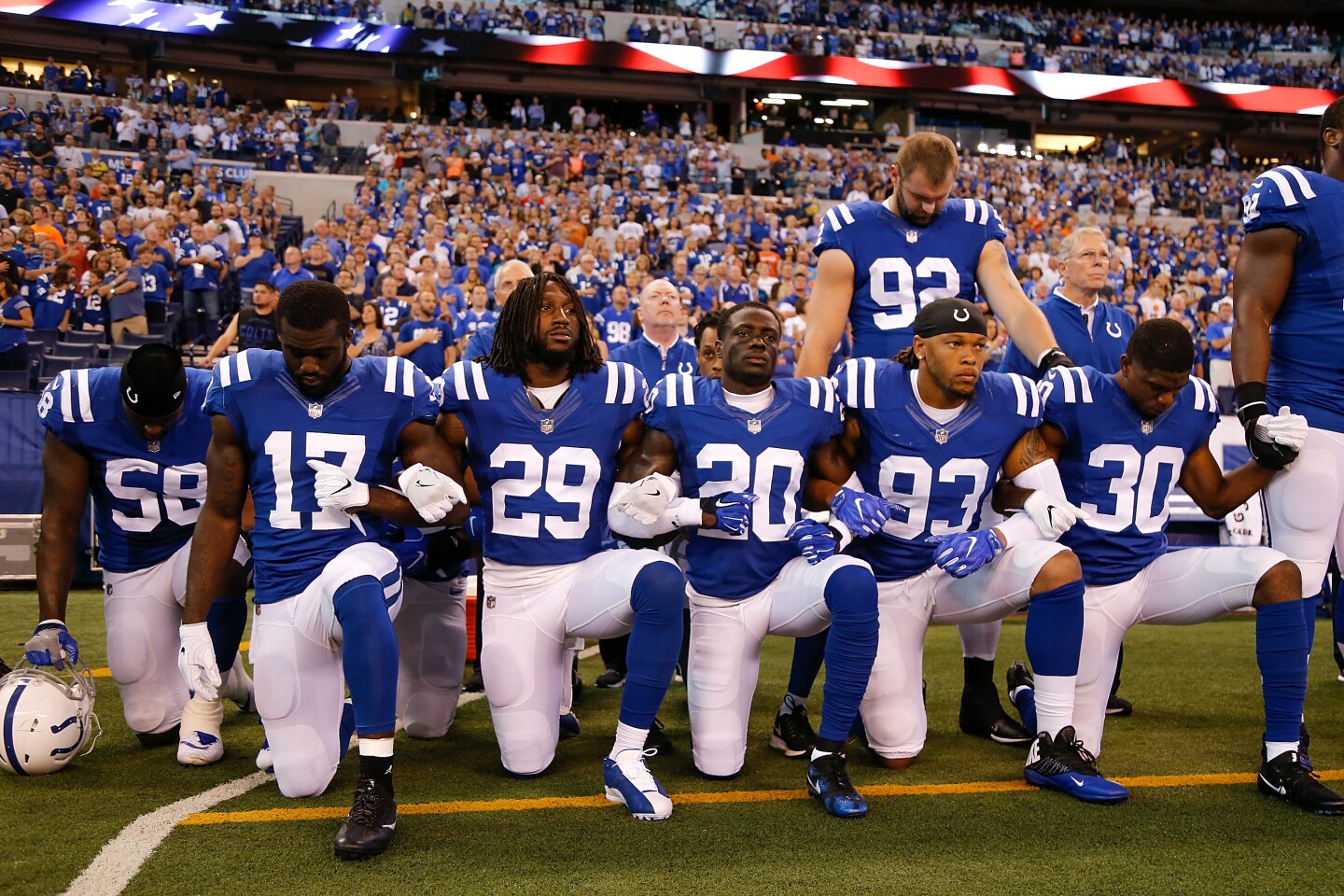 INDIANAPOLIS, IN - SEPTEMBER 24:  Members of the Indianapolis Colts stand and kneel for the national anthem prior to the start of the game between the Indianapolis Colts and the Cleveland Browns at Lucas Oil Stadium on September 24, 2017 in Indianapolis, Indiana.  (Photo by Michael Reaves/Getty Images)