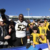 Michael Sam #52 of the Missouri Tigers celebrates with fans after the game against the Kentucky Wildcats at Commonwealth Stadium on November 9, 2013 in Lexington, Kentucky. Missouri won 48-17.  