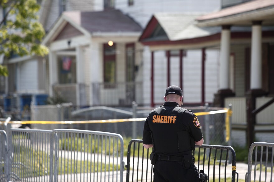 CLEVELAND, OH - MAY 7:  A police officer keeps the public away from the house where three women, who disappeared as teens about a decade ago, were found alive May 7, 2013 in Cleveland, Ohio. Amanda Berry, who went missing in 2003, Gina DeJesus, who went missing in 2004, and Michelle Knight, who went missing in 2002, managed to escape their captors on May 6, 2013. Three suspects, all brothers, were taken into custody.   (Photo by Bill Pugliano/Getty Images)