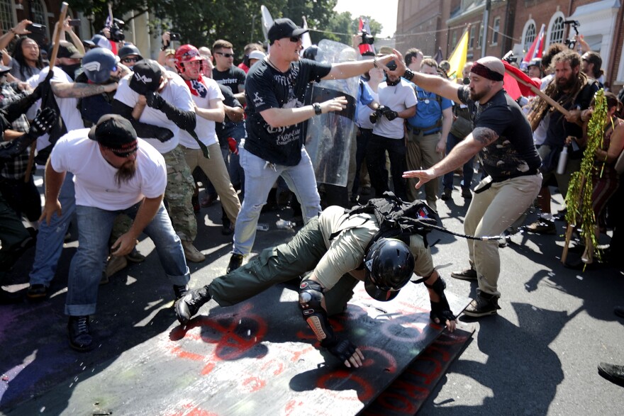 CHARLOTTESVILLE, VA - AUGUST 12:  White nationalists, neo-Nazis and members of the "alt-right" clash with counter-protesters as they enter Emancipation Park during the "Unite the Right" rally August 12, 2017 in Charlottesville, Virginia. After clashes with anti-fascist protesters and police the rally was declared an unlawful gathering and people were forced out of Emancipation Park, where a statue of Confederate General Robert E. Lee is slated to be removed.  (Photo by Chip Somodevilla/Getty Images)