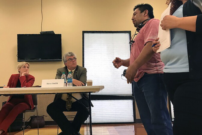 Warehouse worker Luis Martinez tells members of the California Division of Occupational Safety and Health that when he spoke up on behalf of a heat-exhausted temp worker, his supervisor threatened to fire him. 