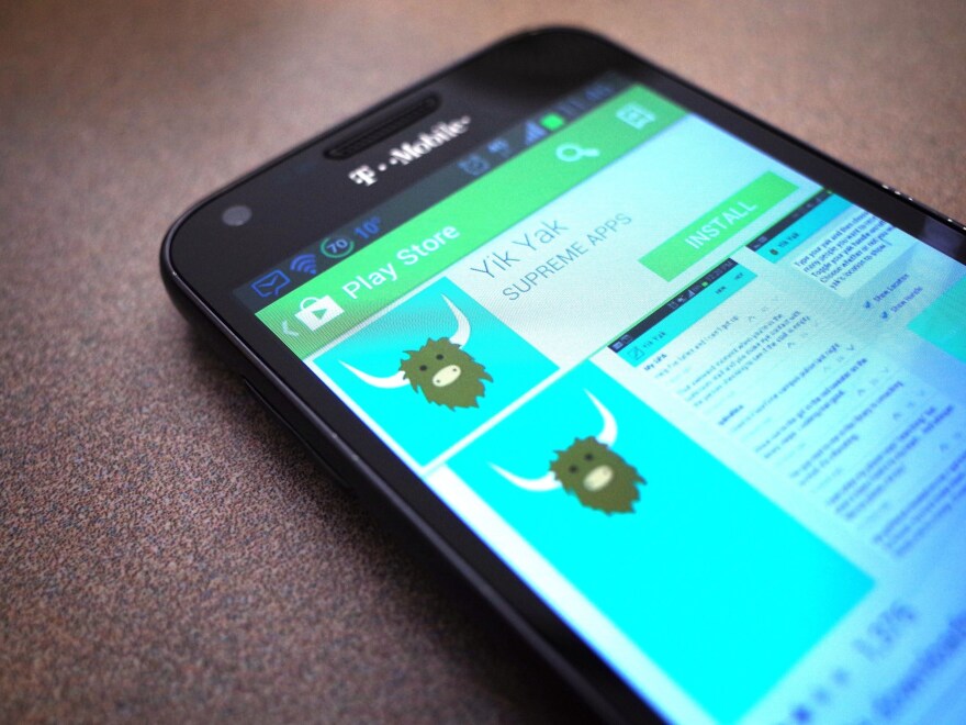 A March 28, 2014, photo illustration shows the Yik Yak app in the Google Play store. A new version is only available currently in the Apple app store in the U.S.