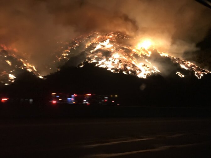 A brush fire broke out along the 405 Freeway at Mulholland Drive shortly before 5 a.m. on Wednesday, Dec. 6, 2017, burning uphill toward the Getty Center.