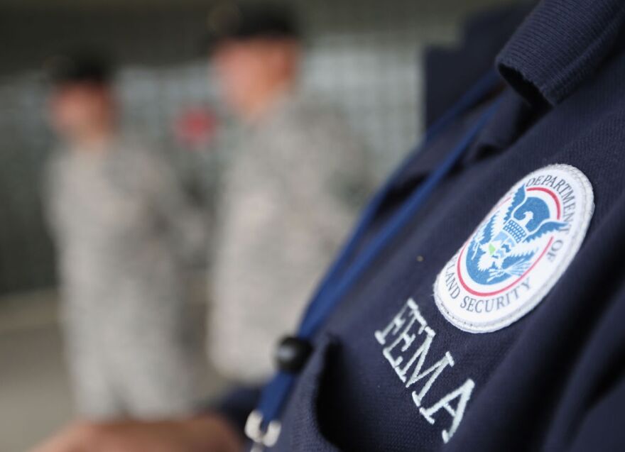 Timothy Henggeler, Logistics Specialist with FEMA speaks with New York guard members at Republic Airport in the aftermath of Hurricane Sandy on October 30, 2012 in Farmingdale, New York. The storm has claimed at least a few dozen lives in the United States, and has caused massive flooding across much of the Atlantic seaboard. U.S. President Barack Obama has declared the situation a "major disaster" for large areas of the U.S. east coast, including New York City.  
