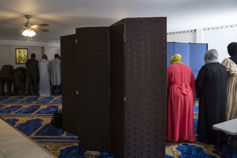 People attend Friday prayer at the mosque in the Assabil shelter.