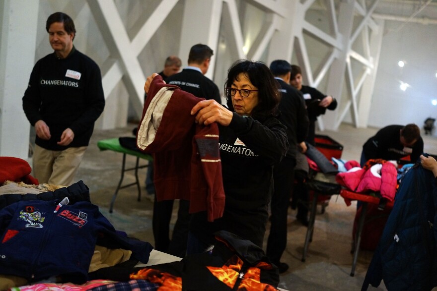 Volunteers sort coats at the annual New York Cares coat drive on December 16, 2013.