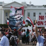  A banner bearing the image of Syrian President Bashar al-Assad is carried by some of the 200 people demonstrating in support of al-Assad and against a possible military attack on Syria by the United States outside the White House September 9, 2013 in Washington, DC. Organized by the Syrian American Forum (SAF),  the demonstrators marched from the White House to the U.S. Capitol.  