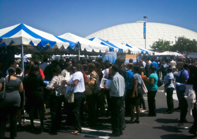 Job seekers crowd the Delta Airlines and BNSF tables in parking lot at Crenshaw Christian Center.
