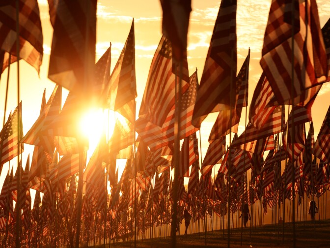 People walk amongst US national flags erected by students and staff from Pepperdine University to honour victims of the 9/11 attacks, in Malibu on September 9, 2012. The 11th anniversary of the 9/11 attacks will fall on September 11. AFP PHOTO / JOE KLAMAR (Photo credit should read JOE KLAMAR/AFP/GettyImages)