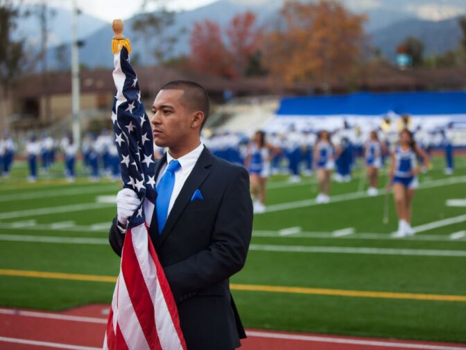 A meber of Banda El Salvador holds the American flag at a performance at Duarte High School.
