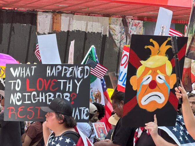 Sign reads: What happened to love thy neighbor? Resist hate