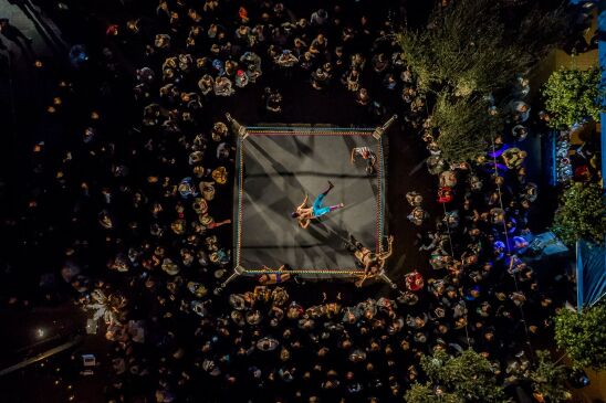 Image of crowd surrounding a wrestling match 