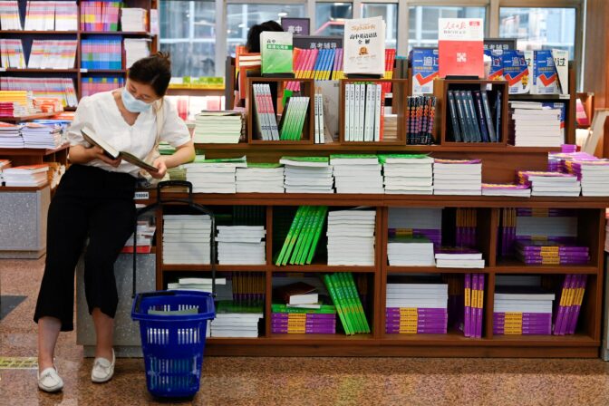 A woman reads a book in a store in Beijing.