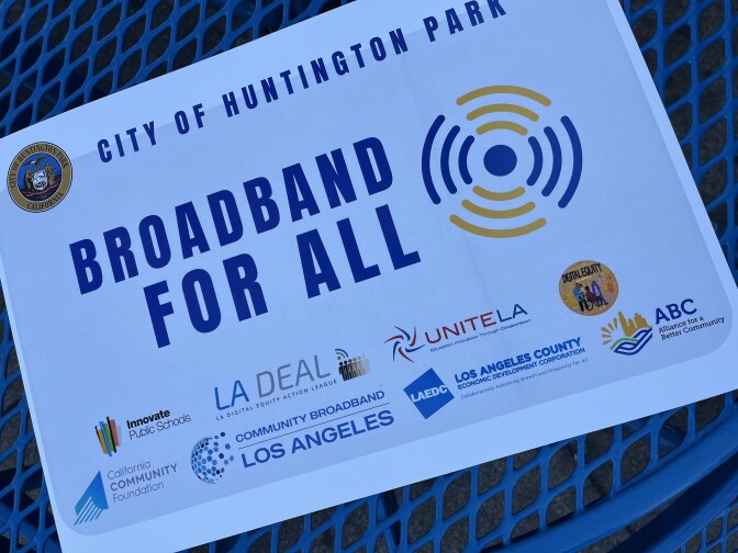 A closeup of a sign that reads "Broadband for All."