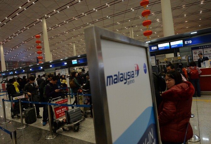 Passengers check in for a Malaysia Airlines flight from Beijing to Kuala Lumpur at China's Beijing Airport on March 10, 2014. Malaysia said a missing airliner carrying 239 people may have inexplicably turned back as authorities launched a terror probe into the plane's sudden disappearance, investigating suspect passengers who boarded with stolen passports. 