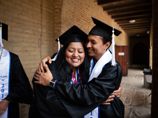 Two undocumented students hug as they are about to graduate from UCLA on June 15, 2012.
