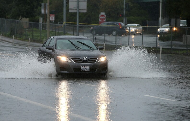File: A car drives through standing water on December 11, 2014 in San Francisco, California. 