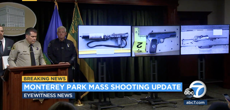 A man in a sheriff's uniform stands at a lectern with other people in uniform nearby. To their left are images of three weapons displayed on screens/